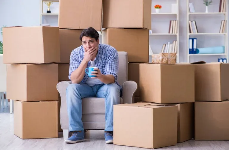 depositphotos_181943122-stock-photo-young-man-moving-in-to